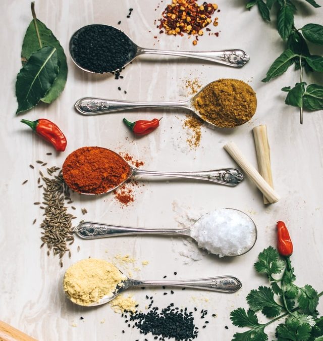 Herbs and plants in spoons on table. Powerful plant medicines.